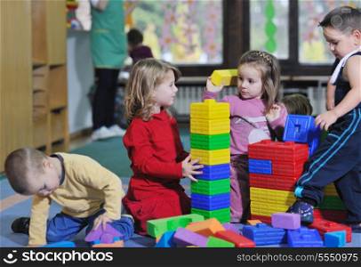 happy child kids group have fun and play at kindergarden indoor preschool education concept with teacher