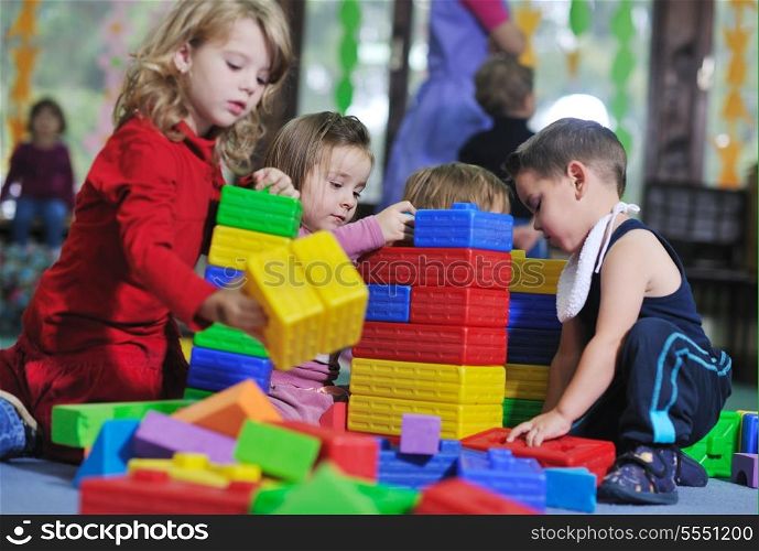 happy child kids group have fun and play at kindergarden indoor preschool education concept with teacher