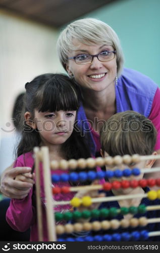 happy child kids group have fun and play at kindergarden indoor preschool education concept with teacher