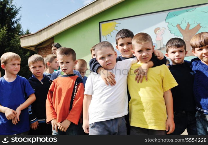 happy child kids group have fun and play at kindergarden outdoor preschool education concept with teacher