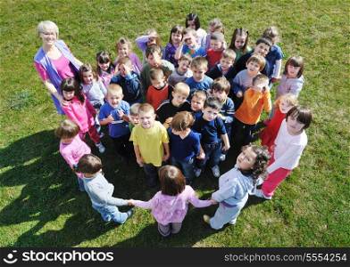 happy child kids group have fun and play at kindergarden outdoor preschool education concept with teacher