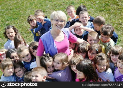 happy child kids group have fun and play at kindergarden preschool education concept with teacher