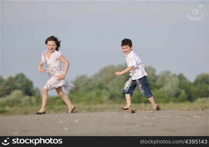 happy child kids have fun and play games on beach