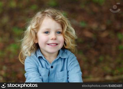 Happy child with long blond hair enjoying the nature. Happy small child with long blond hair enjoying the nature