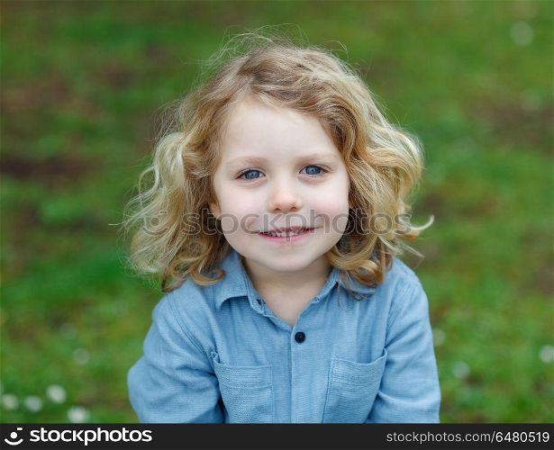 Happy child with long blond hair enjoying the nature. Happy small child with long blond hair enjoying the nature