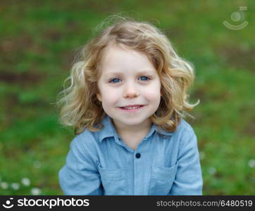 Happy child with long blond hair enjoying the nature. Happy small child with long blond hair enjoying the nature