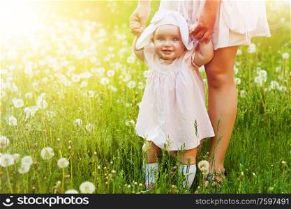 happy child with mother on the field