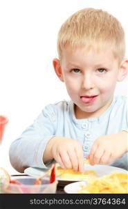 Happy childhood. Boy child kid preschooler eating peeled apple fruit or making batter for drop scones. At home.