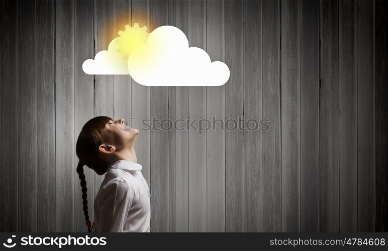 Happy childhood. Cute girl of school age looking at sun above head