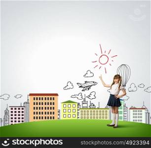 Happy childhood. Cute girl of school age pointing with finger upwards
