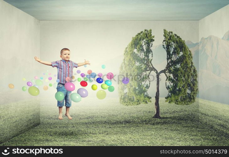 Happy childhood. Little cute boy in jump and colorful balloons around