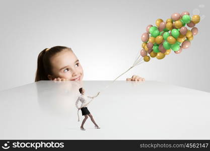 Happy childhood. Little cute girl and woman with bunch of colorful balloons