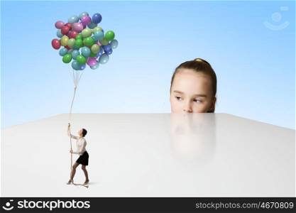 Happy childhood. Little cute girl and woman with bunch of colorful balloons