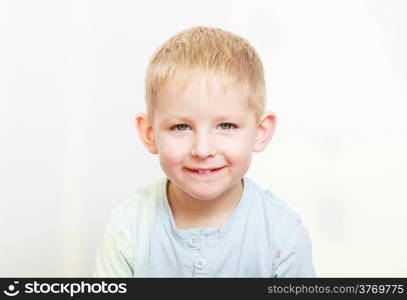 Happy childhood. Portrait of smiling blond boy child kid preschooler in casual clothes. Indoor.