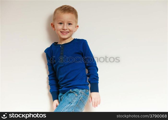 Happy childhood. Portrait of smiling blond boy child kid preschooler in casual clothes. Indoor.