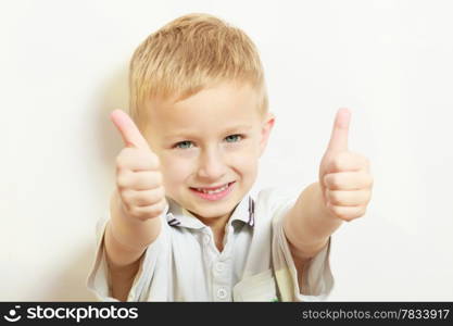 Happy childhood. Portrait of smiling blond boy child kid preschooler showing thumb up success hand sign gesture. Indoor.