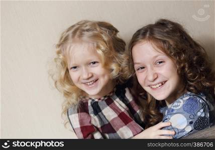 happy childhood. two sisters smiling faces close up looking at the camera