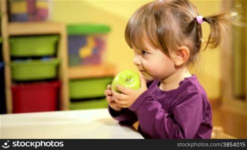 Happy children and healthy food, baby girl eating fruit at school. Sequence