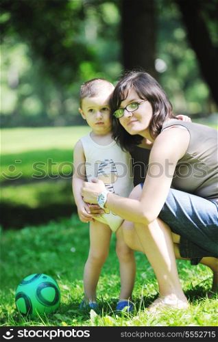 happy children and mom have fun at beautiful park on summer season