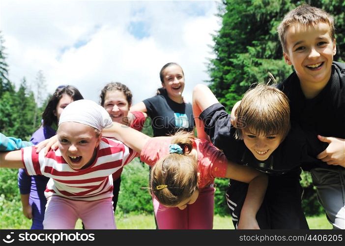 happy children group have fun outdoor in nature at suny day