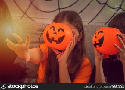 Happy children in costumes and makeup for celebration of Halloween.A boy holding Pumkin in hands at Halloween day.