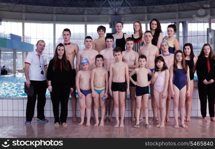 happy children kids group at swimming pool class learning to swim