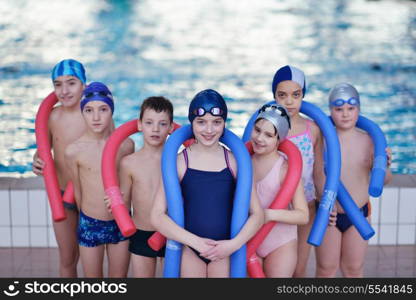 happy children kids group at swimming pool class learning to swim