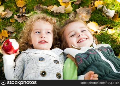 Happy children playing in autumn park on family picnic