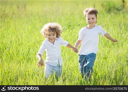Happy children playing in spring field