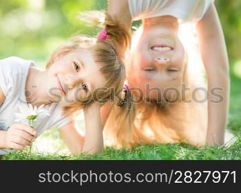 Happy children playing outdoors in spring park