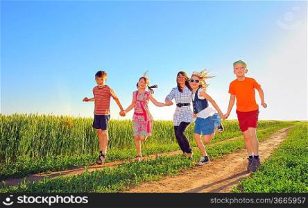 happy children shoot on field in summer time
