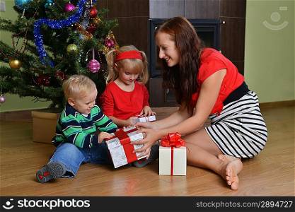 happy children with mother near Christmas tree