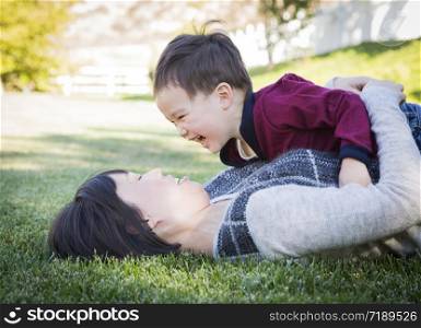 Happy Chinese Mother Having Fun with Her Mixed Race Baby Son.