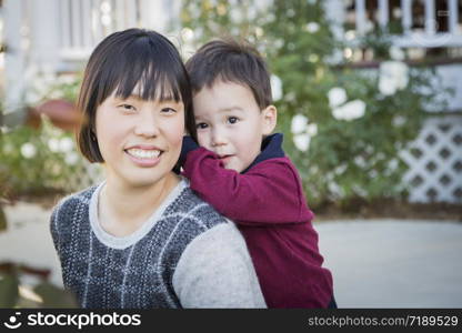 Happy Chinese Mother Having Fun with Her Mixed Race Baby Son.
