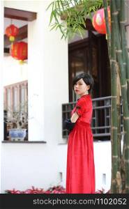 happy Chinese new year. beautiful young Asian woman dress traditional cheongsam