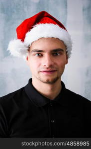 Happy Christmas man. Christmas celebration portrait of young adult happy man wearing Santa hat