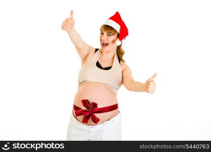 Happy christmas pregnant woman in Santa hat showing thumb up gesture isolated on white &#xA;