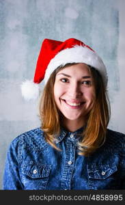 Happy Christmas woman. Christmas celebration portrait of young adult happy woman wearing Santa hat