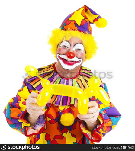 Happy clown holding a balloon dog he has made. Isolated on white.