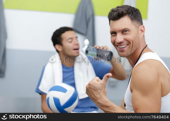 happy coach and player talking in changing room