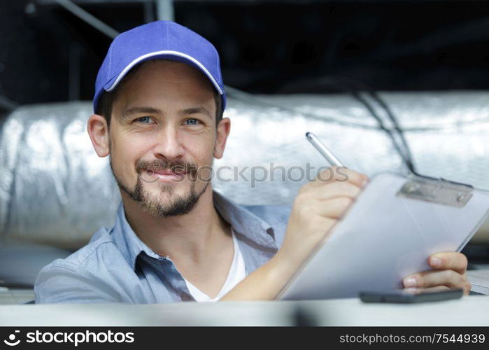 happy construction builder checking clipboard inside site