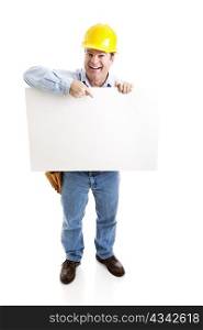 Happy construction worker pointing to a blank white sign. Full body isolated on white.