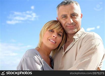 Happy couple against a blue sky