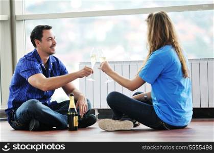 happy couple at big bright comfort apartment celebrate with glasses of champagne