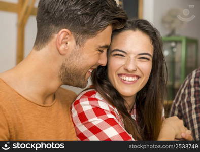 Happy couple at the restaurant talking and smiling