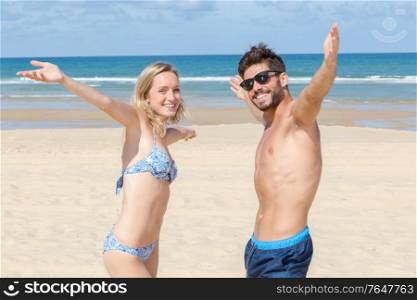 happy couple beach fun on travel holiday beach vacation