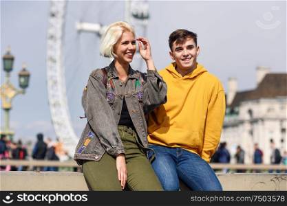 Happy couple by westminster bridge, River Thames, London. UK. Young couple of friends enjoying view during travel.. Happy couple by westminster bridge, River Thames, London. UK.