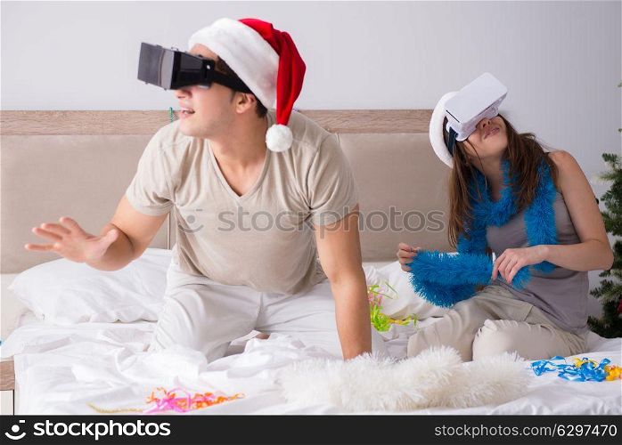 Happy couple celebrating christmas holiday in bed