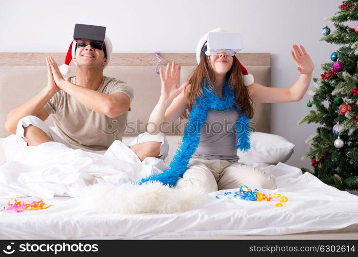 Happy couple celebrating christmas holiday in bed