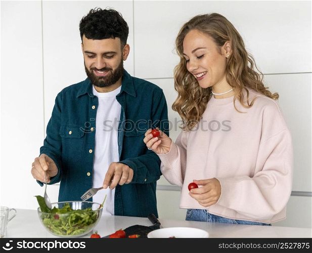 happy couple cooking together home